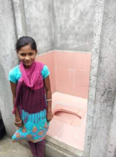 Young indian child happy to have a toilet at home